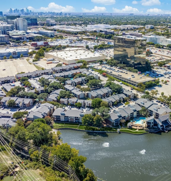 an aerial view of a city with a river and buildings at Lakeside Apartments, Texas, 75231